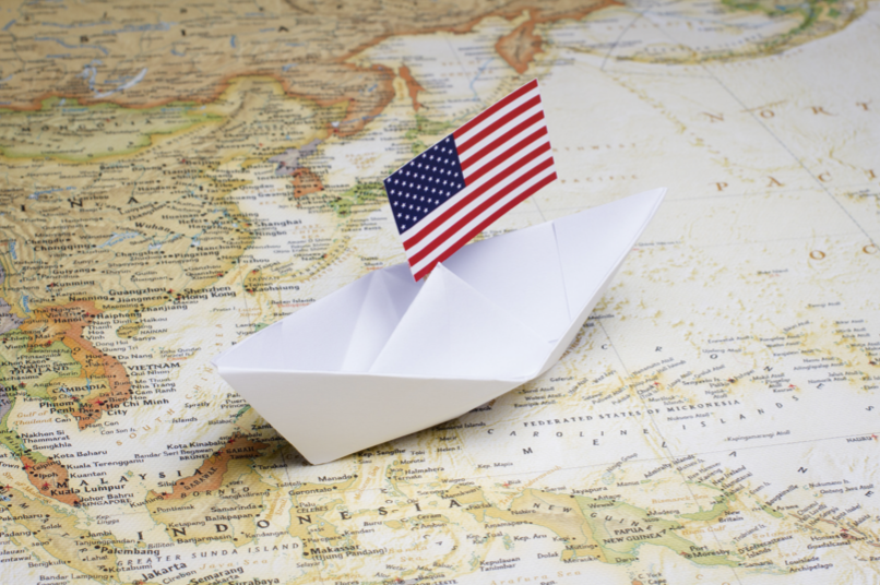 us-flag-on-paper-boat-on-old-map.png